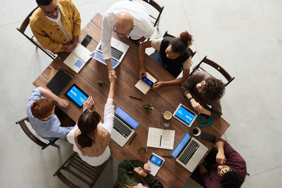 Team meeting in a modern office environment discussing staffing and recruitment
